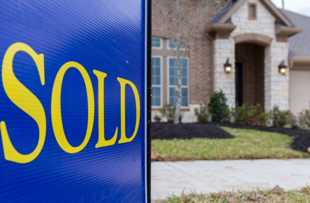Sold sign in front of a house.