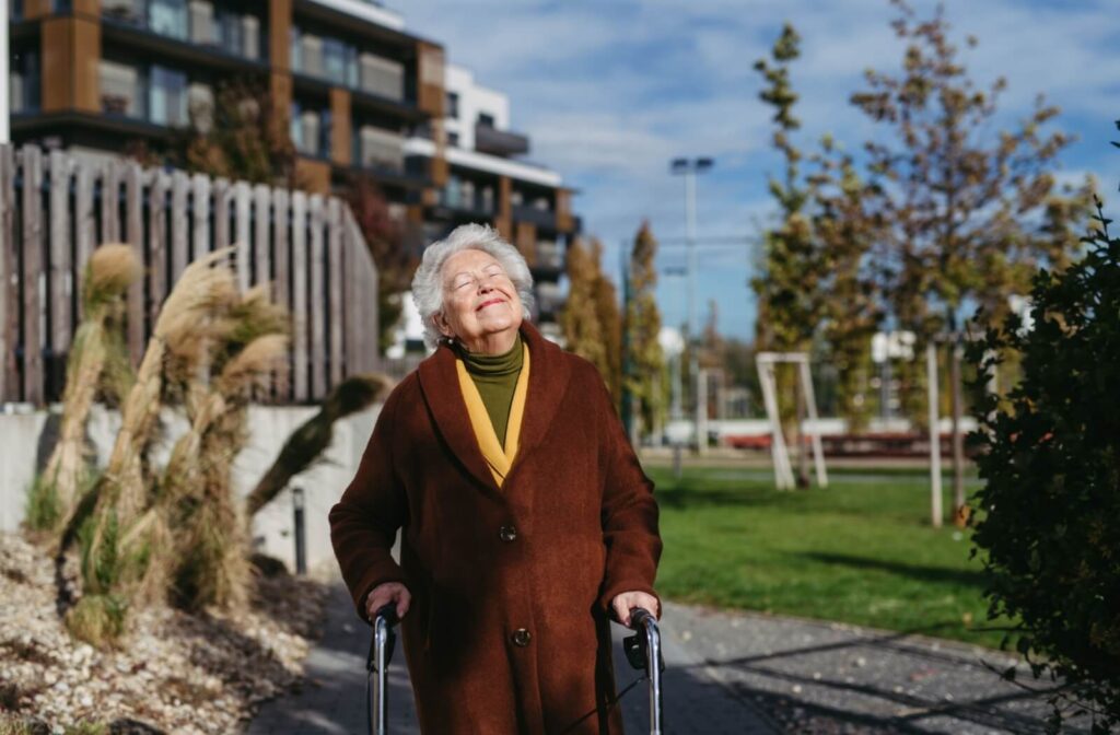 A senior with dementia enjoys their daily afternoon walk around the secure grounds of their memory care community